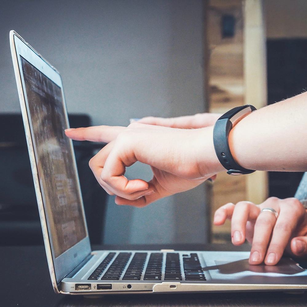 somebody pointing at a notebook screen